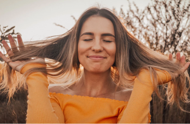 Woman putting fingers through her hair